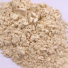 Close-up of light beige ginseng powder showing fine particles, coarse pieces, and visible soft clumping