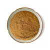 Fenugreek seed powder top view in a ceramic dish for botanical supplement formulation and ingredient development
