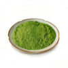 Fine green kale powder in a ceramic dish for capsule and greens powder blend formulations