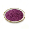 Fine purple sweet potato powder in a ceramic dish for beverage mix and nutrition powder formulation