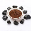 Shilajit powder with dark source material, presented as a fine brown ingredient for supplement formulation