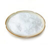 Angled view of xylitol powder in a ceramic dish for chewable product and confectionery formulation