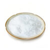 Fine white aloe vera extract powder with a soft, slightly uneven surface in a shallow ceramic dish against a white background