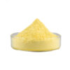 Side view of a small mound of yellow apigenin powder in a shallow glass dish against a plain white background.