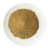 Overhead view of celery-derived apigenin powder showing a loose mound of finely divided tan powder in a white ceramic plate.