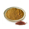 Golden-brown Chinese prickly ash extract powder displayed in a ceramic dish beside a small pile of reddish peppercorn-like material