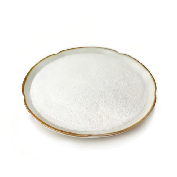 Side-angle view of finely textured white ferulic acid powder forming a gentle mound inside a shallow ceramic dish with a brown rim