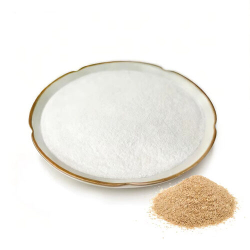 Fine white ferulic acid powder in a ceramic dish beside a separate mound of coarse beige material on a white background