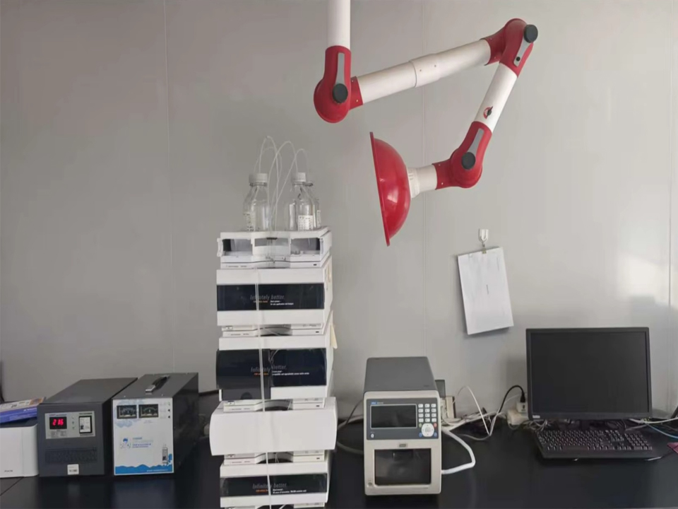 Laboratory technician using HPLC chromatography equipment to analyze marker compounds in standardized botanical extracts.
