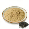 Close angled view of Jiaogulan extract powder showing its fine beige texture and small clumps, with dried leaves beside the dish