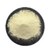 Luteolin powder from Sophora japonica bud extract displayed as a pale yellow-beige mound on a black circular slate