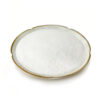 Side-angle presentation of monk fruit extract powder showing its fine off-white texture and loose powder form in a ceramic plate.