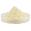 Side view of pale yellow naringin powder forming a small mound in a shallow transparent glass dish, showing its fine texture