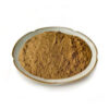 Angled view of fine tan-brown botanical extract powder heaped in a shallow ceramic dish