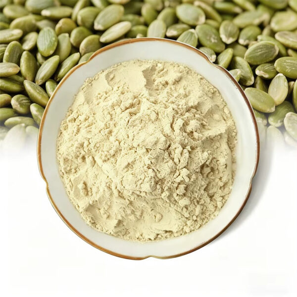 Pumpkin seed extract powder in a shallow white ceramic bowl with green hulled pumpkin seeds across the background