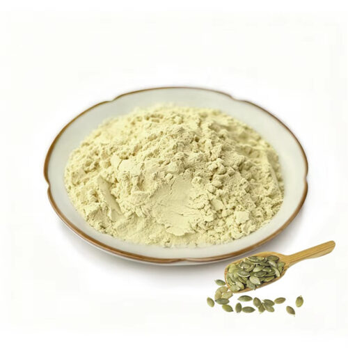 Pumpkin seed extract powder on a white ceramic dish beside a wooden scoop holding green hulled pumpkin seeds