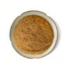 Top view of Rhodiola rosea root extract powder in a shallow ceramic dish, showing its light brown color and uneven powder texture