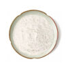 Top-down view of trans-resveratrol powder showing an off-white surface with fine particles and irregular clumps in a ceramic dish