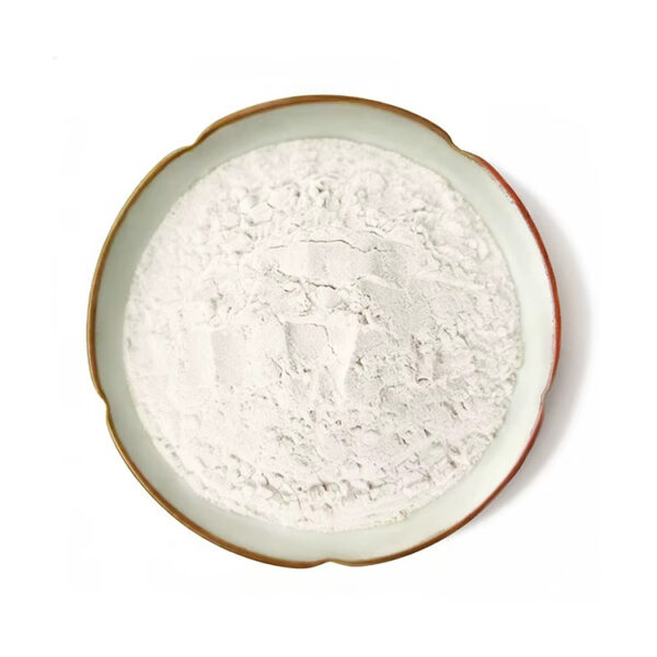 Top-down view of trans-resveratrol powder showing an off-white surface with fine particles and irregular clumps in a ceramic dish