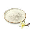 Cream-colored vanilla powder on a shallow plate beside a pale vanilla flower and dark pods on a white background.
