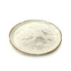 Pale vanilla powder with a fine, slightly clumped texture piled on a cream ceramic plate against a white background.