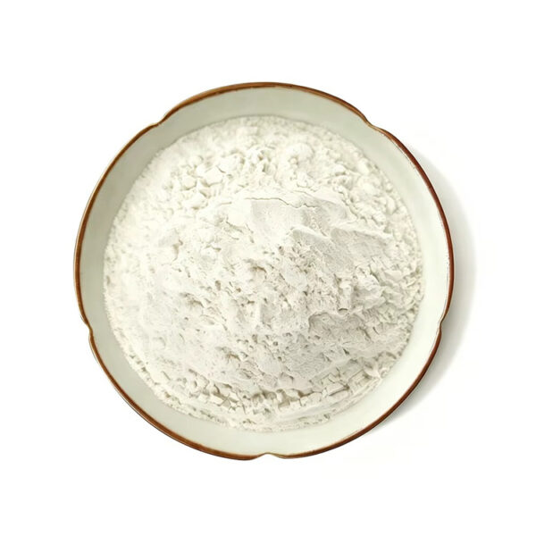 Overhead view of off-white vanilla powder filling a scalloped cream ceramic plate against a white background.